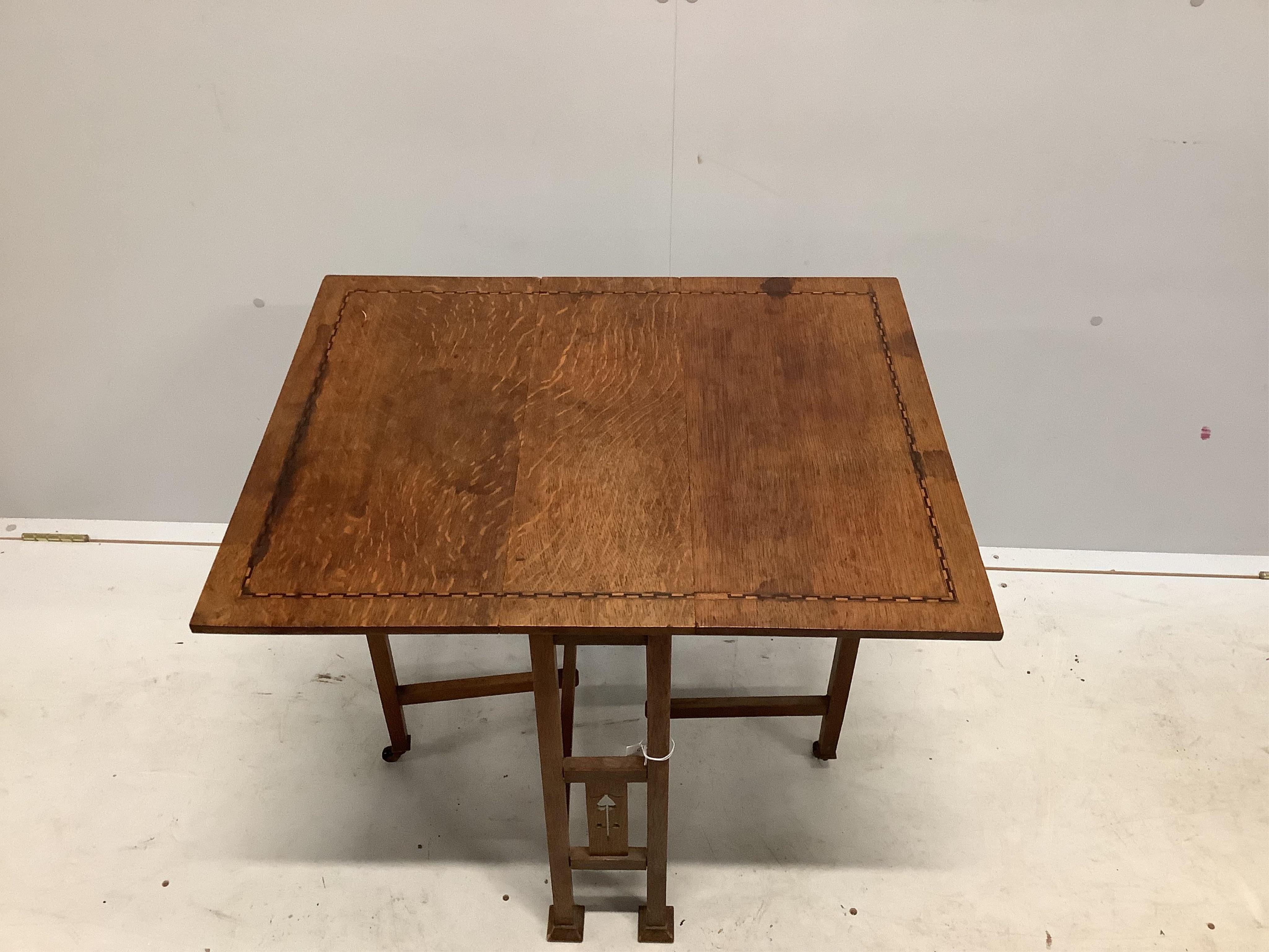 An Arts & Crafts inlaid oak Sutherland table, probably by Liberty of London, width 56cm, depth 20cm, height 60cm. Condition - fair